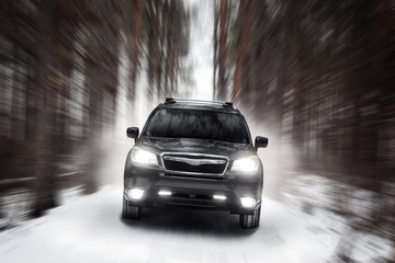 Obraz na płótnie Canvas Black car speed drive on off road at winter daytime