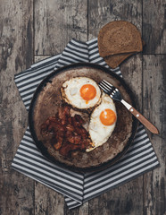 Vintage photo of tasty homemade meal photographed from above on old rustic wooden table.