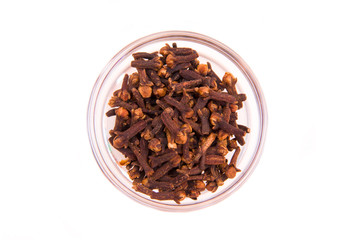 cloves on bowl on white background seen from above
