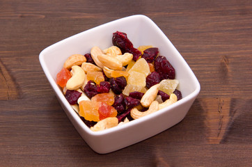 Dried fruits on a square bowl on wooden table
