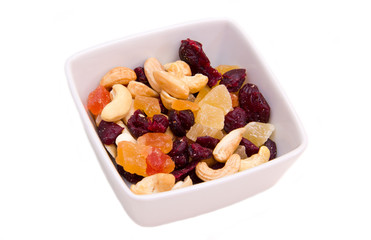 Dried fruits on square bowl on a white background