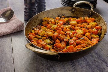 Roasted vegetables in a metal serving bowl