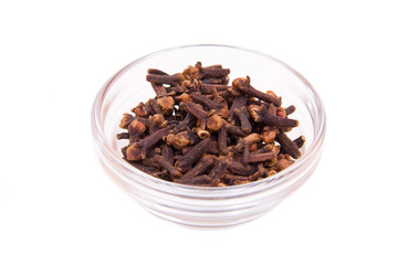 cloves on a glass bowl on white background