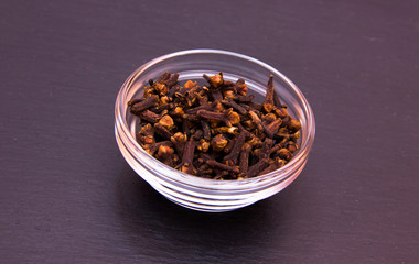 cloves on glass bowl on slate top