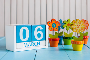 March 6th. Image of march 6 wooden color calendar with flower on white background.  First spring...