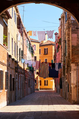 Fototapeta na wymiar Laundry hanging out of a typical Venetian facade. Italy