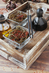 seaweed and chopsticks, on an open wooden table