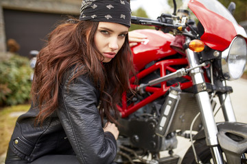 Obraz na płótnie Canvas woman repair a motorbike