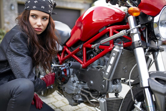 woman repair a motorbike