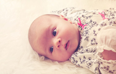 Newborn baby laying on her blanket