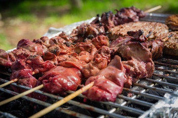 Different types of meat are cooked on the grill - close up