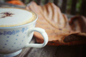 Cappuccino coffee with dried leaves
