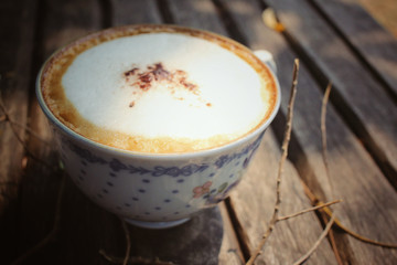 Cappuccino coffee with branch tree