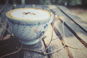 Cappuccino coffee with branch tree
