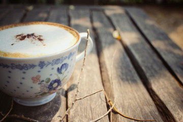 Cappuccino coffee with branch tree