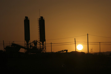 cement tanks in a sunset