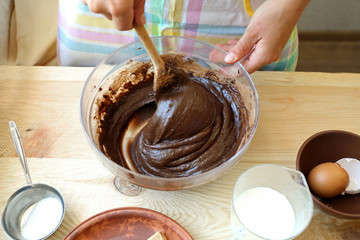 Preparing dough for chocolate pie on table close up