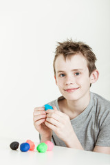 Boy playing with clay on table