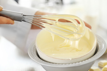 Cooking buttery cream on kitchen