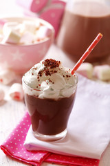 Glass of chocolate milk on table close-up