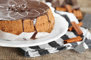 Tasty chocolate cake on wooden background