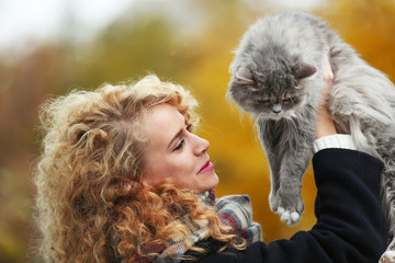 Young woman and cat in the park