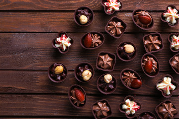 Fototapeta na wymiar Chocolate sweets on wooden background