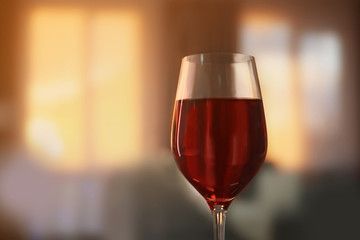 Glass of red wine on blurred background