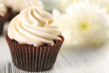 White cupcakes on wooden table