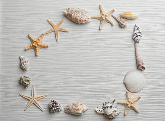 Frame shaped seashells on light background