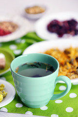 Cup of tea with aromatic dry tea on wooden background
