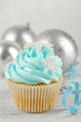 Tasty blue cupcake with decorations, closeup