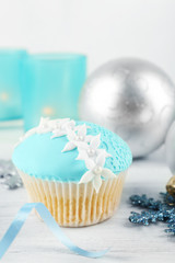 Tasty blue cupcake with decorations, closeup