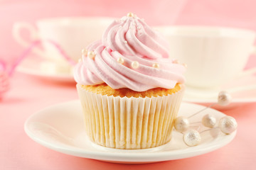 Tasty cupcakes with tea set and decorations, closeup