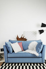 Beautiful modern living room with blue sofa and floor lamp