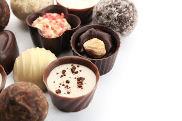Assorted collection of chocolate candies and sweets, isolated on white