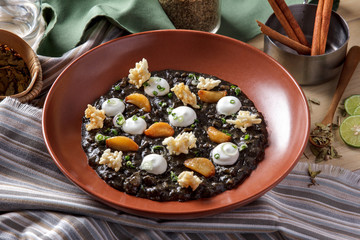 black squid risotto served as tapas