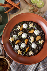 a plate of black squid risotto