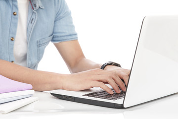 man typing on a laptop
