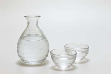 Sake cup and bottle on white background
