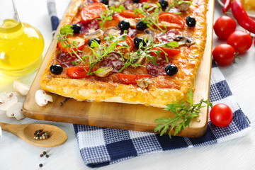 Rectangle delicious pizza and vegetables on the table