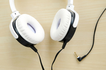 White headphones on wood background