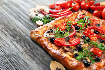 Freshly homemade pizza on wooden background
