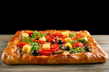 Freshly homemade pizza on black background