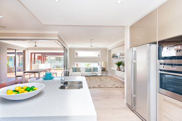 View of a living room and an exterior patio from the modern kitc