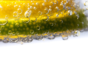 Closeup macro of lemon and limes submerged in sparkling water