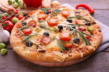 Delicious fresh pizza on wooden table closeup