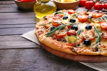 Delicious fresh pizza on wooden table closeup