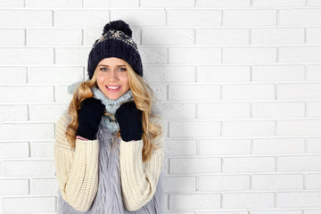 Winter portrait of young beautiful blond woman in her knitted warm clothing