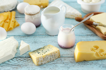 Set of fresh dairy products on blue wooden table, close up